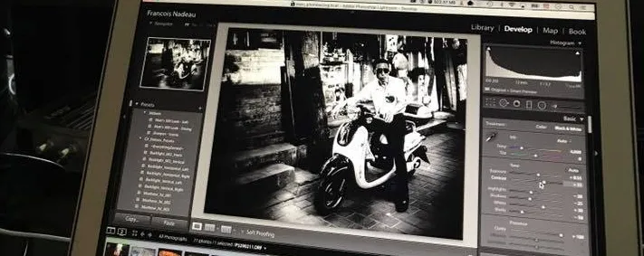 Screen showing Lightroom’s Develop module, with a black-and-white photo of a person on a scooter